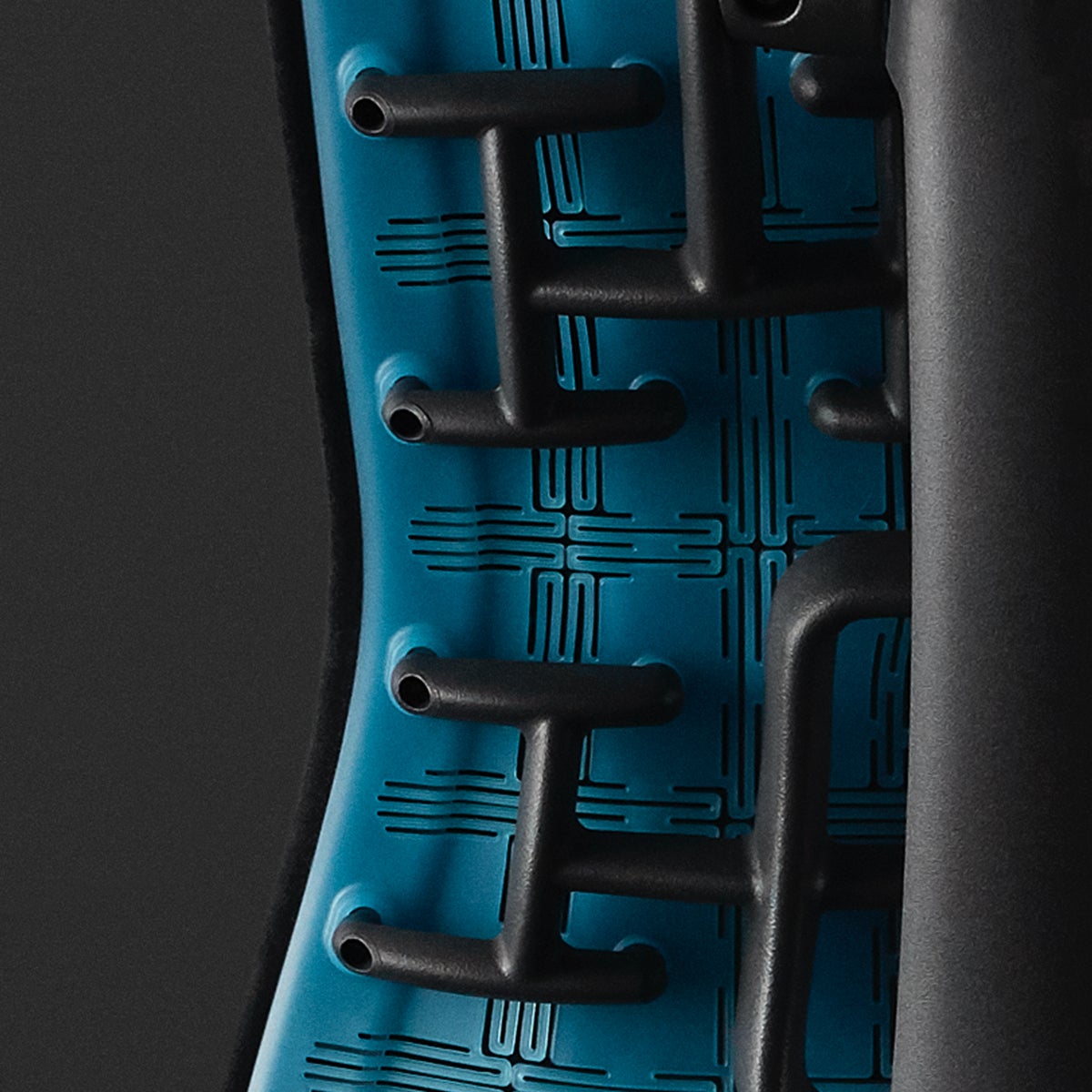 Embody Gaming Chair close-up of cyan matte back and spine with a black background.