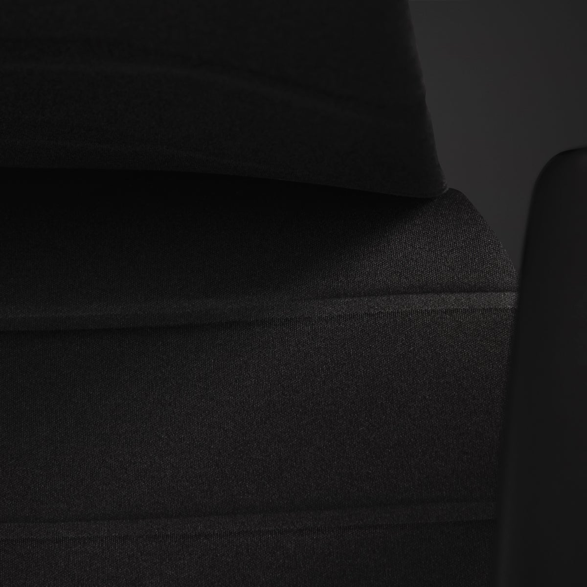 An Embody Gaming Chair close-up on the seat’s layered technology with a black background.